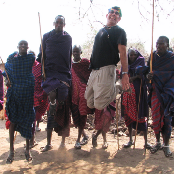 Bob Siegel jumping with local tribe men in Africa