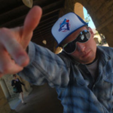 Tom McFadden posing and wearing glasses and baseball cap