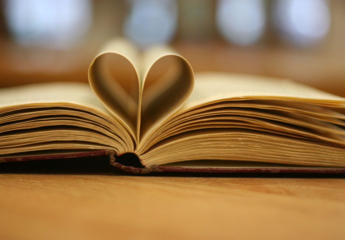 Open book with pages folded into a heart